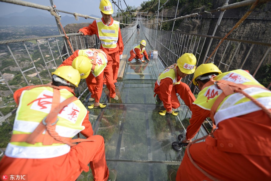 Só para corajosos: Trabalhadores chineses substituem vidro em ponte suspensa a 180 metros do nível do solo