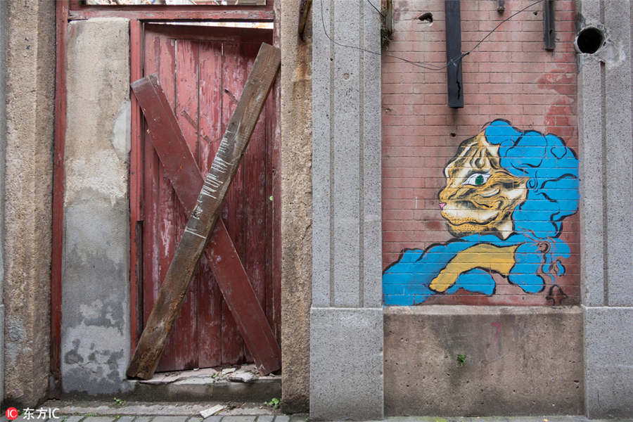 Graffitis d?o nova vida a local em demoli??o em Shanghai