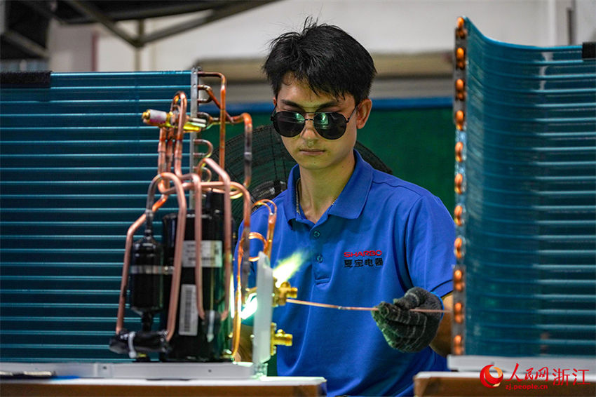 Zhejiang: operários fabricam produtos de exporta??o para países ao longo do Cintur?o e Rota