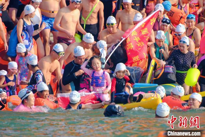 Mais de 3.000 entusiastas da nata??o atravessam rio Yongjiang, no sul da China