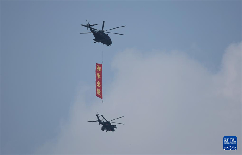 Marcha do desfile militar do Dia da Vitória da China come?a com esquadr?o de guarda de bandeiras sobrevoando Pra?a Tian'anmen