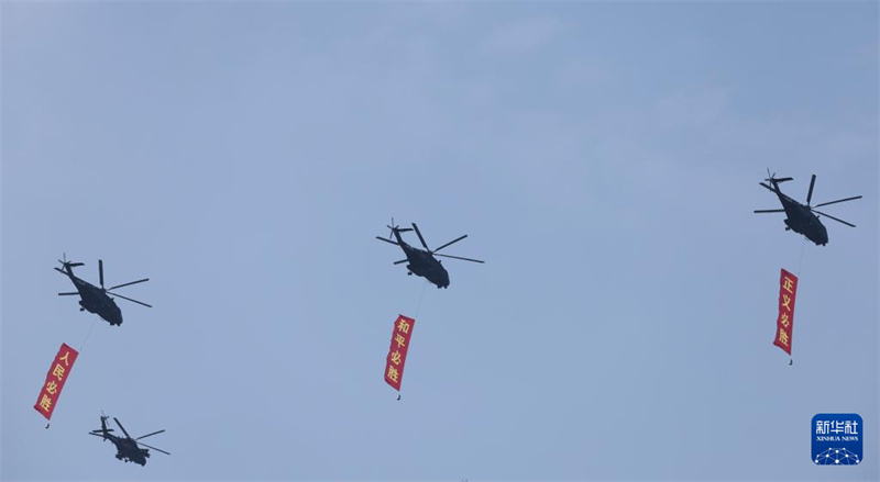 Marcha do desfile militar do Dia da Vitória da China come?a com esquadr?o de guarda de bandeiras sobrevoando Pra?a Tian'anmen
